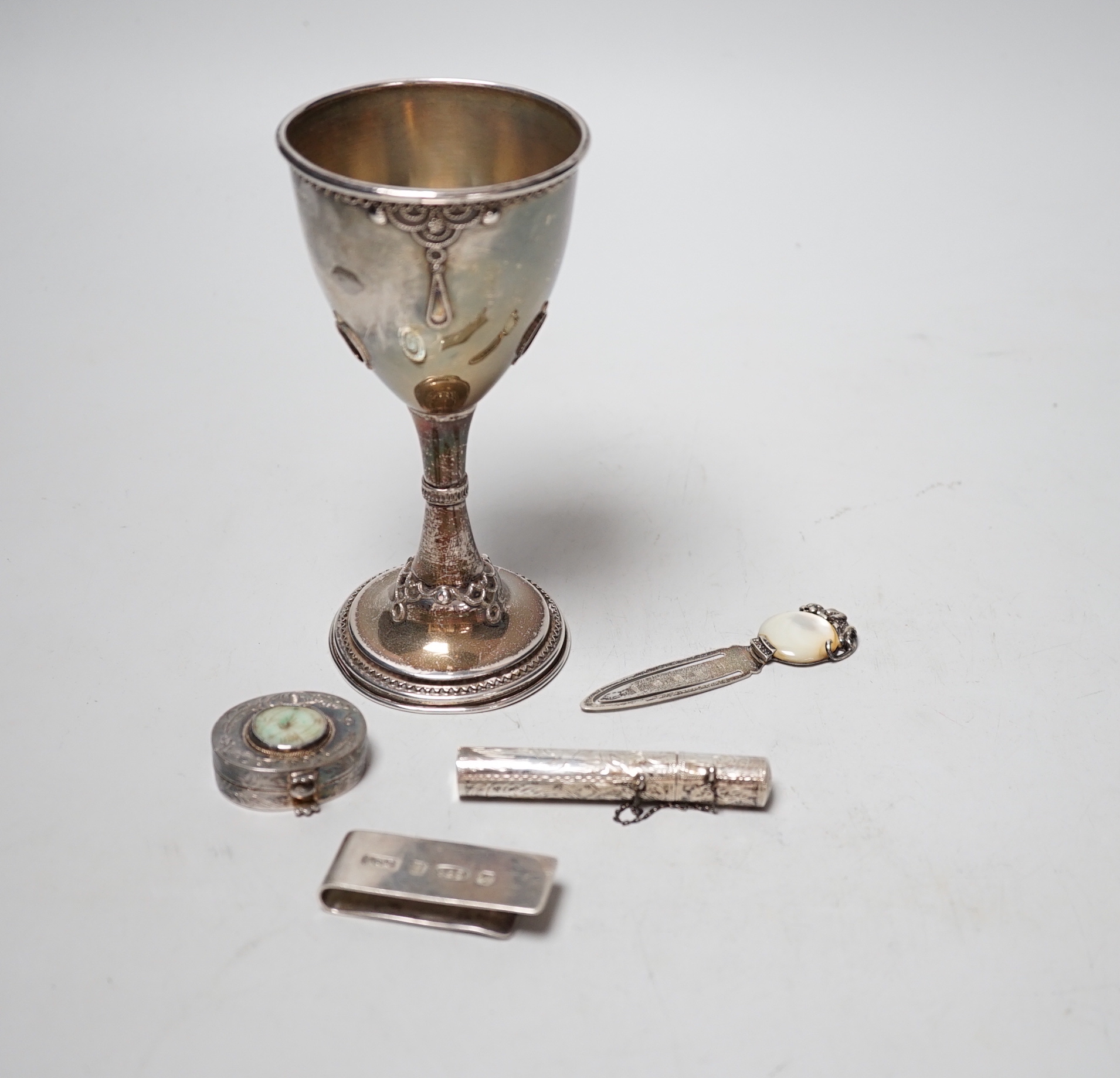 A 1960's silver and turquoise set goblet, import marks for London, 1966 (stones missing), 14.1cm and four small silver or white metal items including a bookmark and money clip.